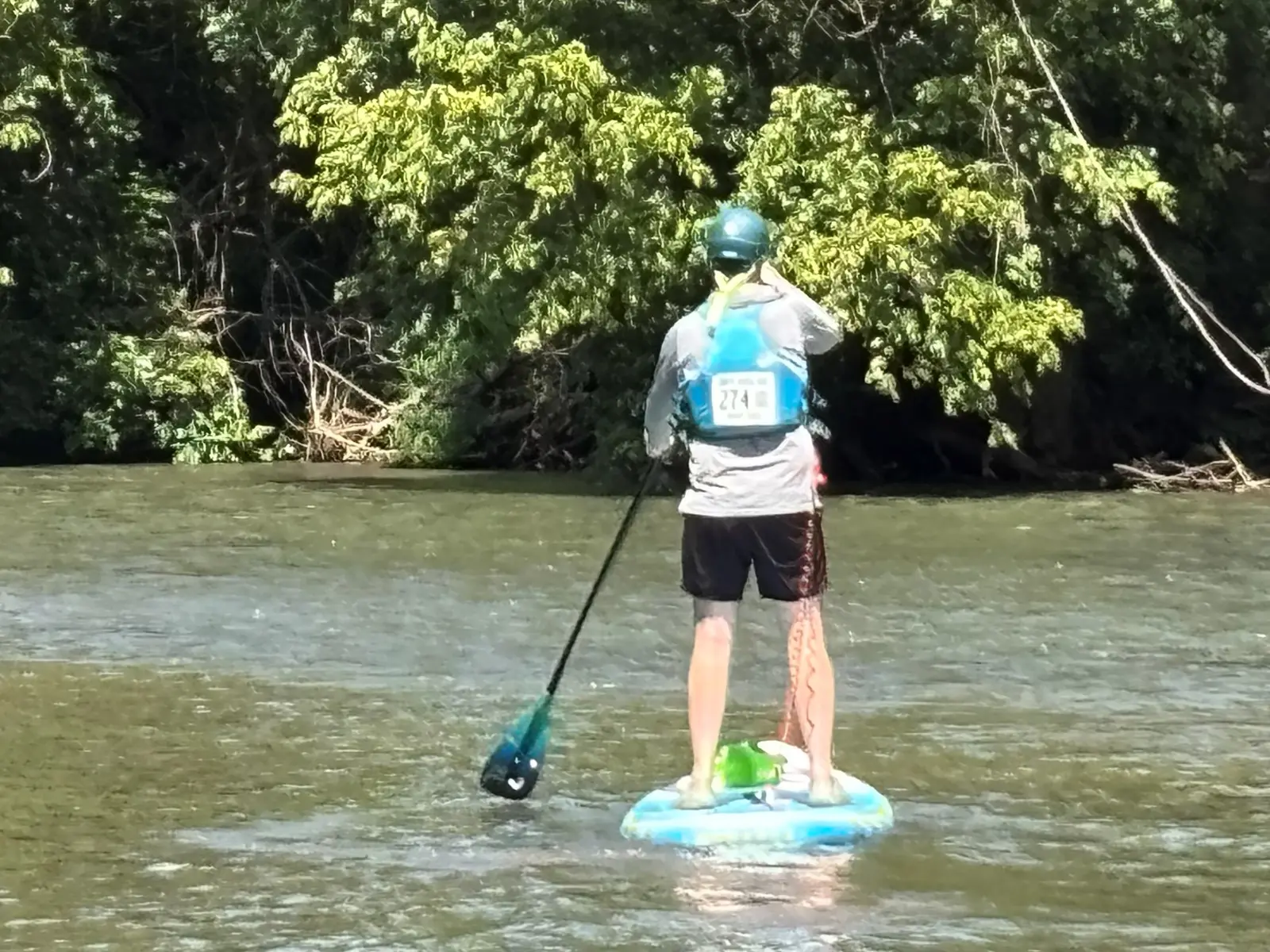 A guest paddleboarding on the Smith River